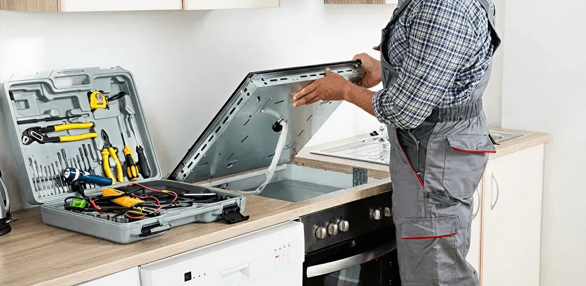 Handyman repairing a cooktop and checking wiring connections in Reno, NV