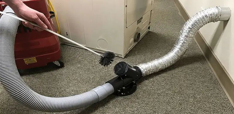 Dryer vent cleaning service removing lint from a dryer duct connection in Reno, NV