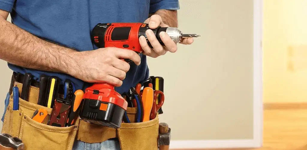 Handyman holding a power drill for home repairs and installations in Reno, NV