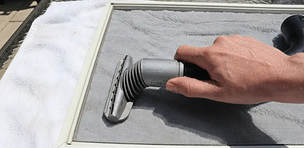 Window screen repair cleaning and fixing a damaged screen mesh in Reno, NV